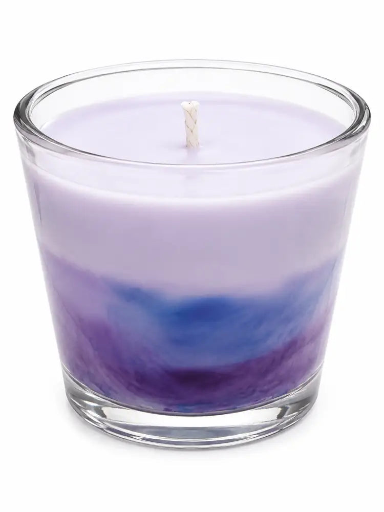 Marbled wax candle in clear glass with light purple and blue swirl and white wick