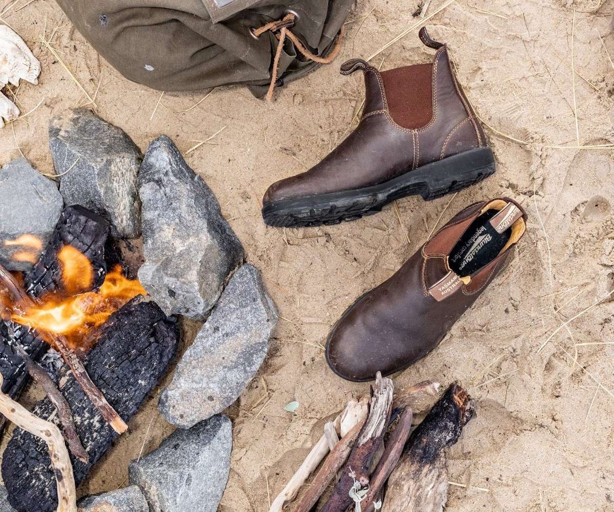 Men's walnut brown Chelsea boots on stone ground, elastic panels visible