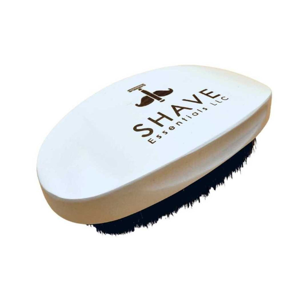 White beard brush with black bristles and SHAVE ESSENTIALS logo