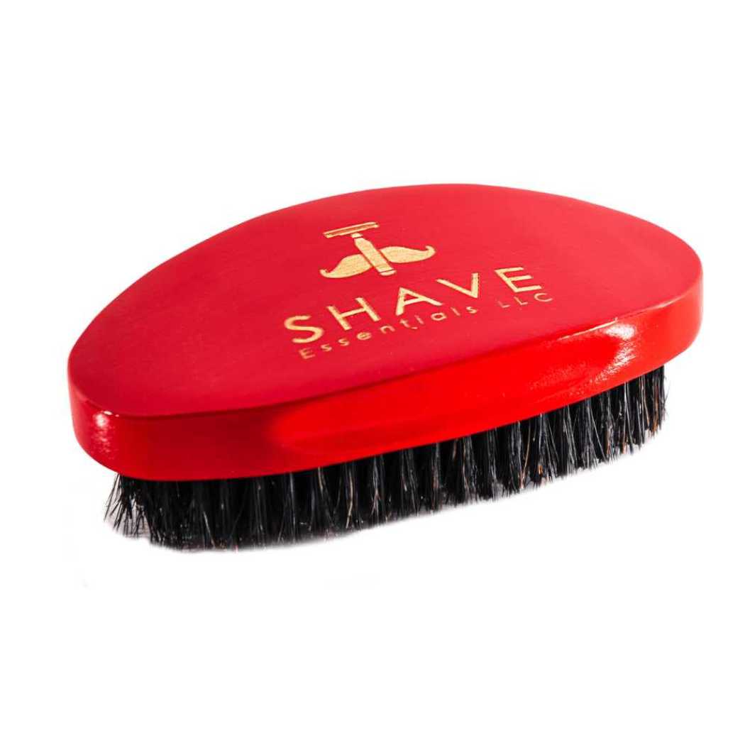 Red beard brush with black bristles and SHAVE ESSENTIALS logo