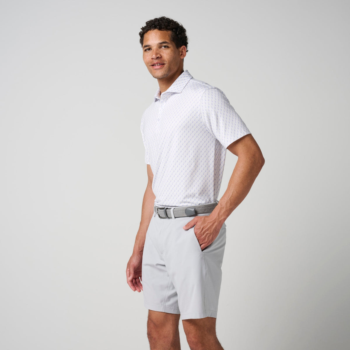 Light patterned performance polo with short sleeves and collared neckline, side stance