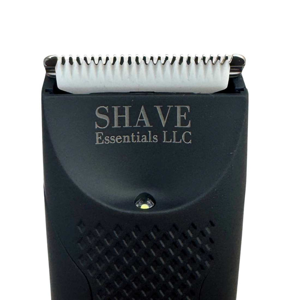 Close-up of black shaver head showing metal blades and brand text on housing