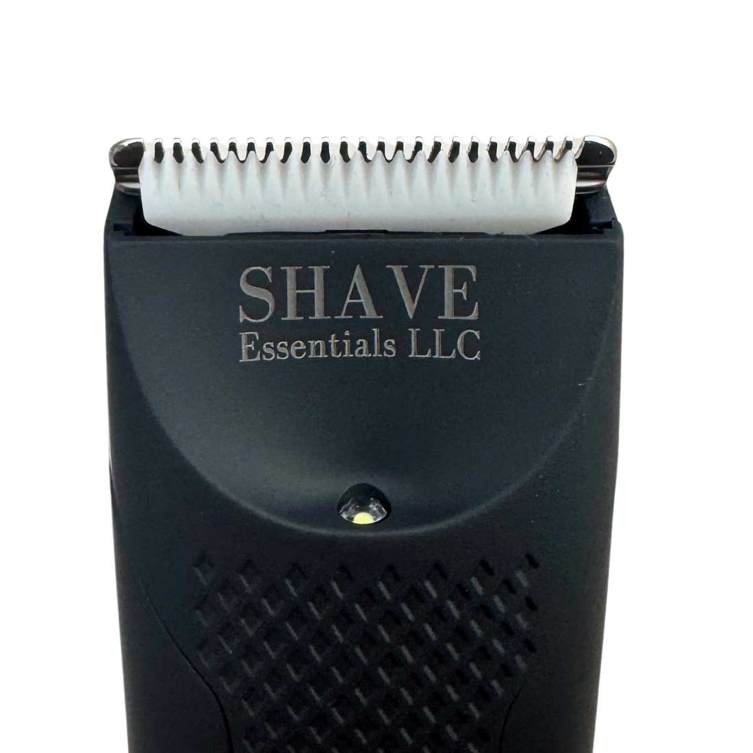 Close-up of black shaver head showing metal blades and brand text on housing
