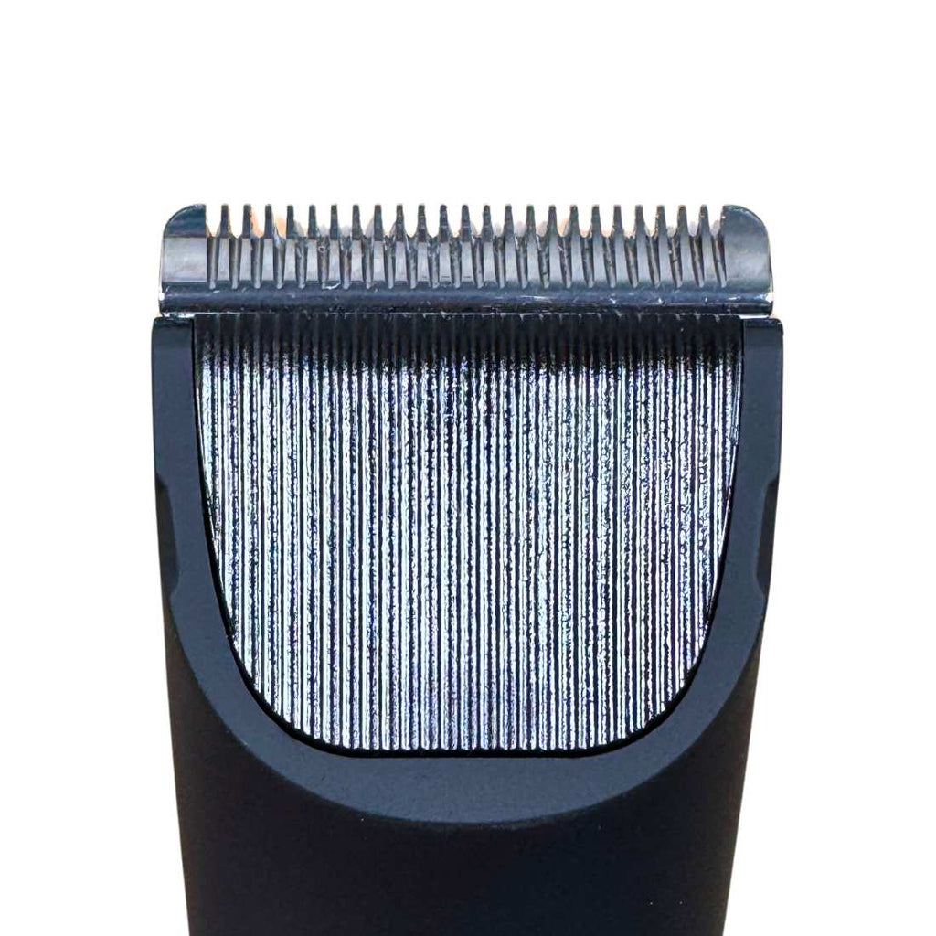 Close-up of metal cutting blades on a black electric grooming shaver head