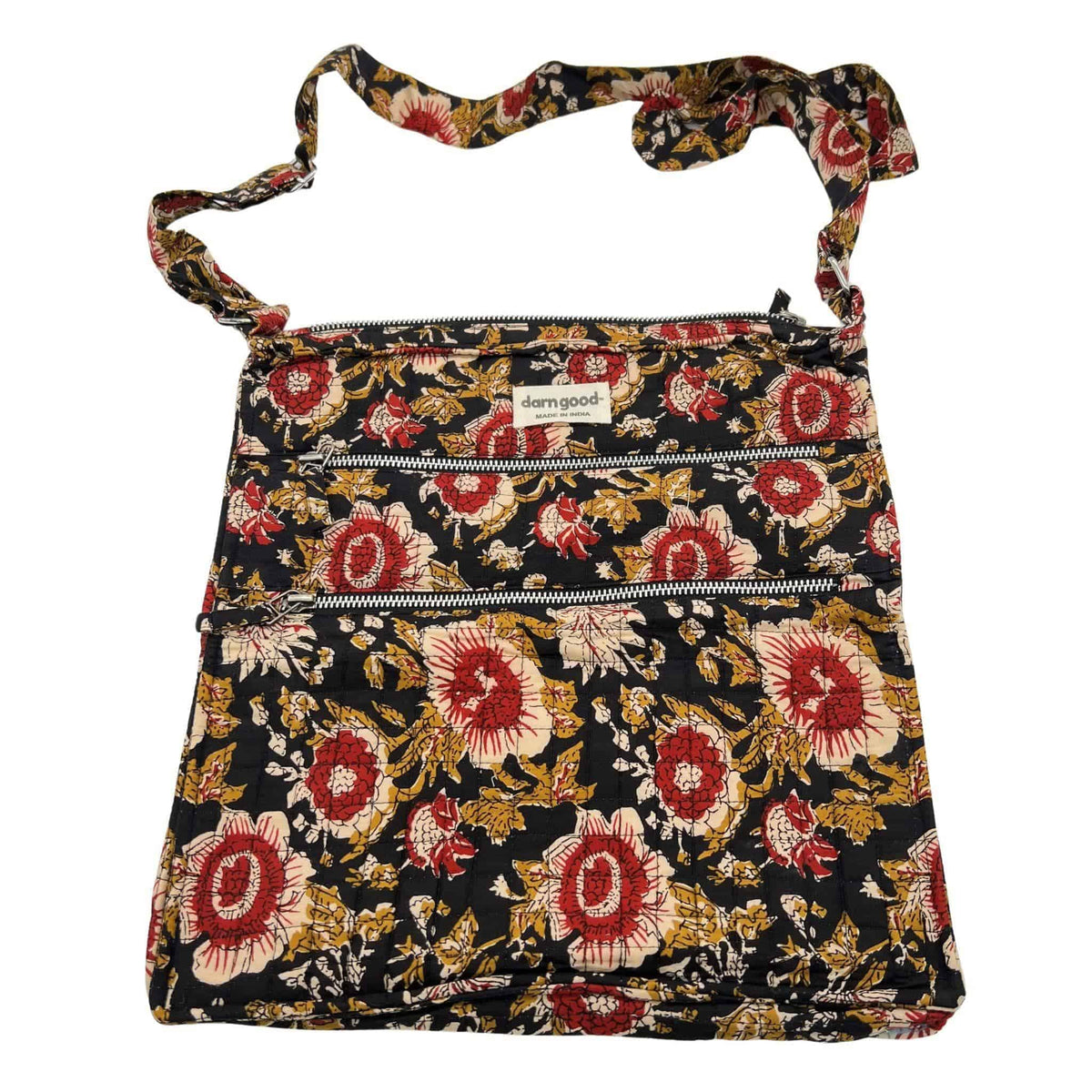 Floral patterned crossbody bag in black with red and cream accents, top zip closure