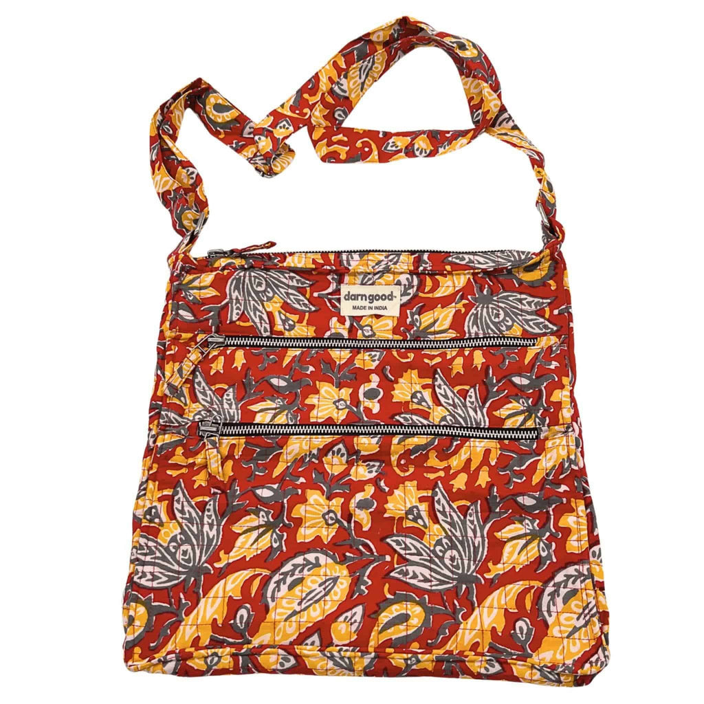 Boho patchwork crossbody bag with orange, red, and yellow floral pattern and zip front