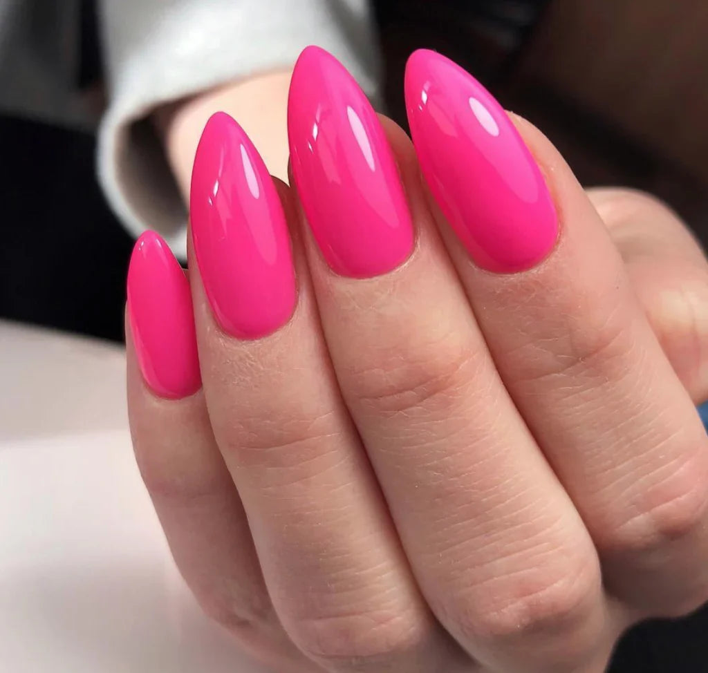 Bright fuchsia gel nails with glossy finish, long oval shape