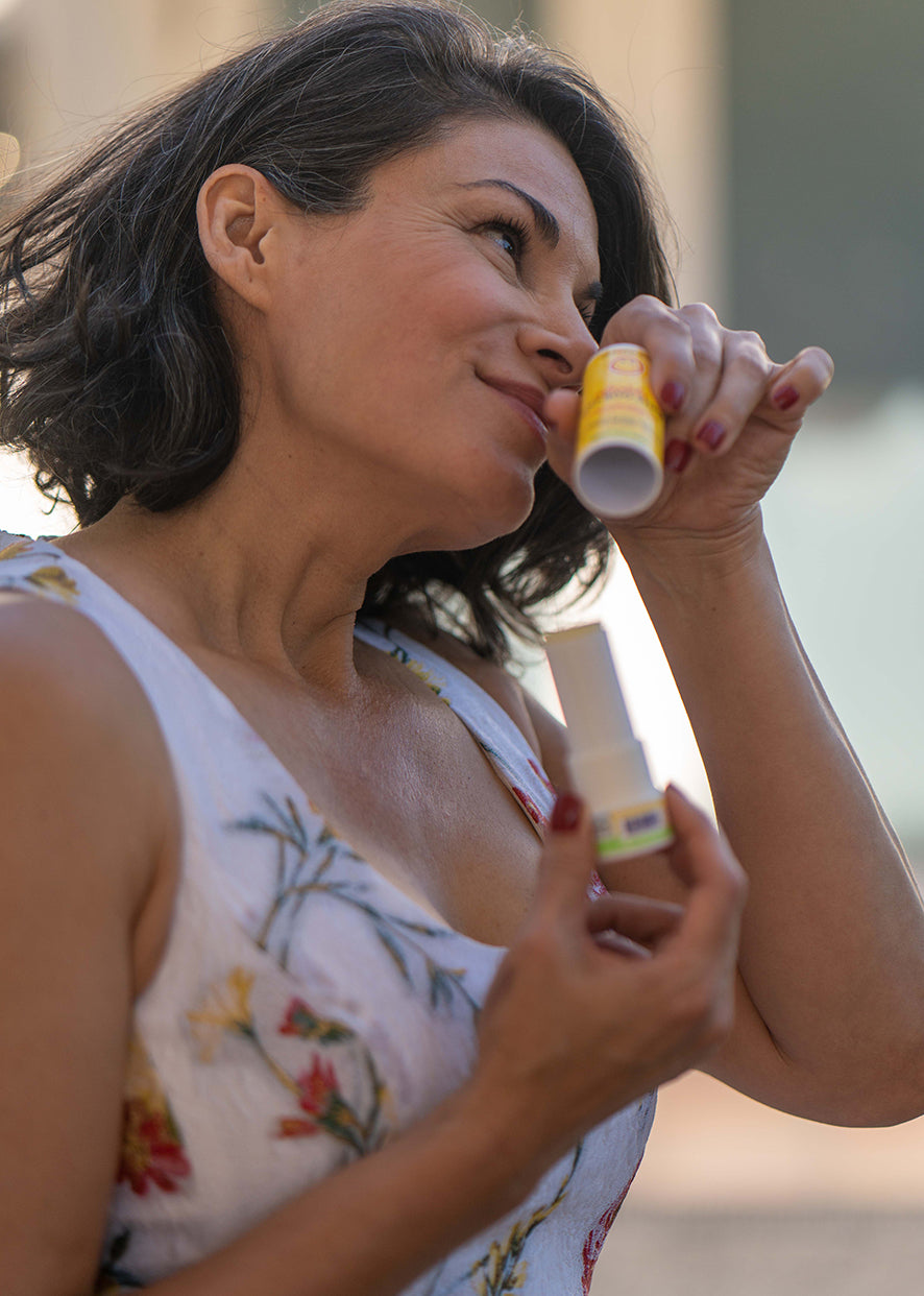 Boo-Boo stick use, woman and child holding small yellow balm tube