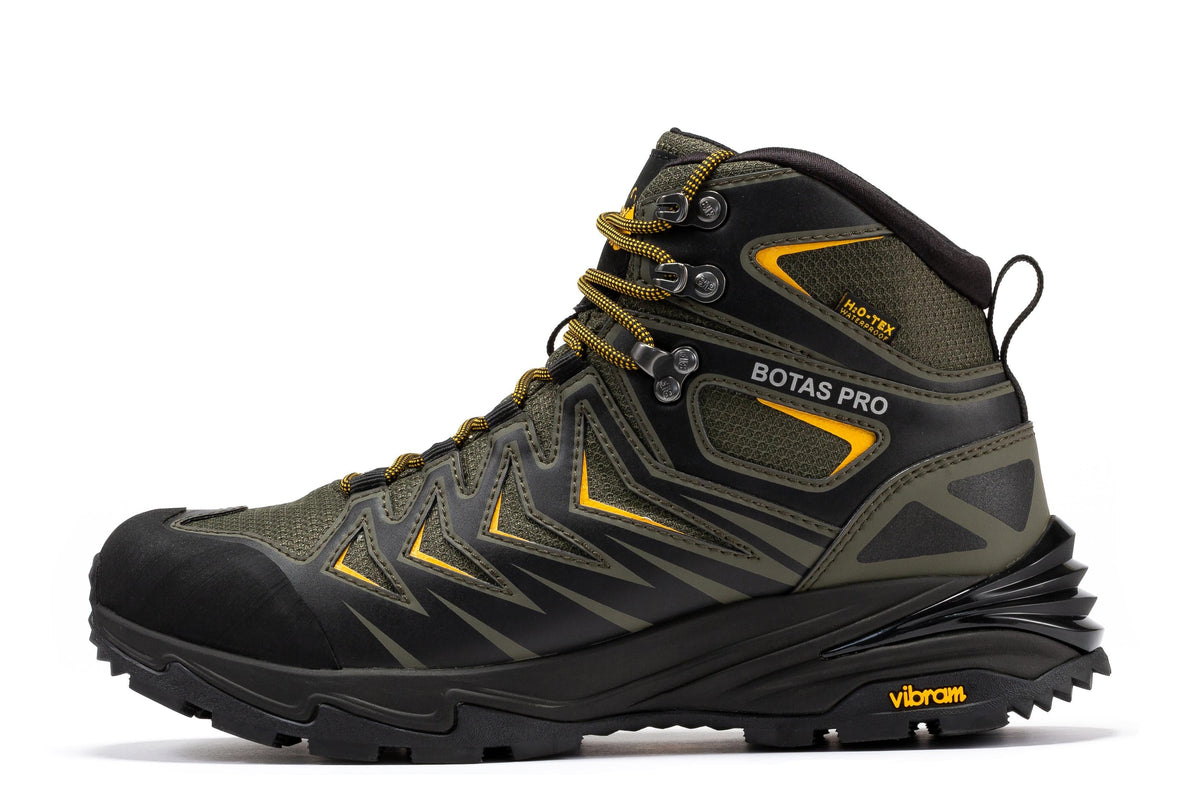 Waterproof hiking boot, angled view in dark green with yellow accents and VIBRAM tread