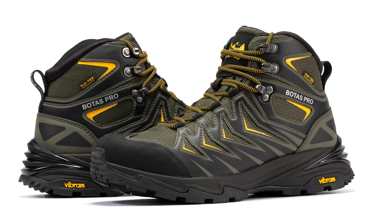 Pair of waterproof 6-inch hiking boots, dark green uppers with yellow laces and chunky soles