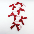 Red velvet bow garland with multiple tied bows on red string