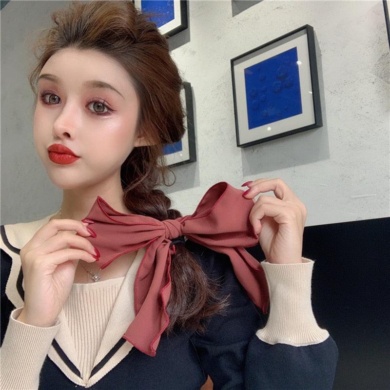 Burgundy bowknot hair scrunchie with long tied tails on ponytail