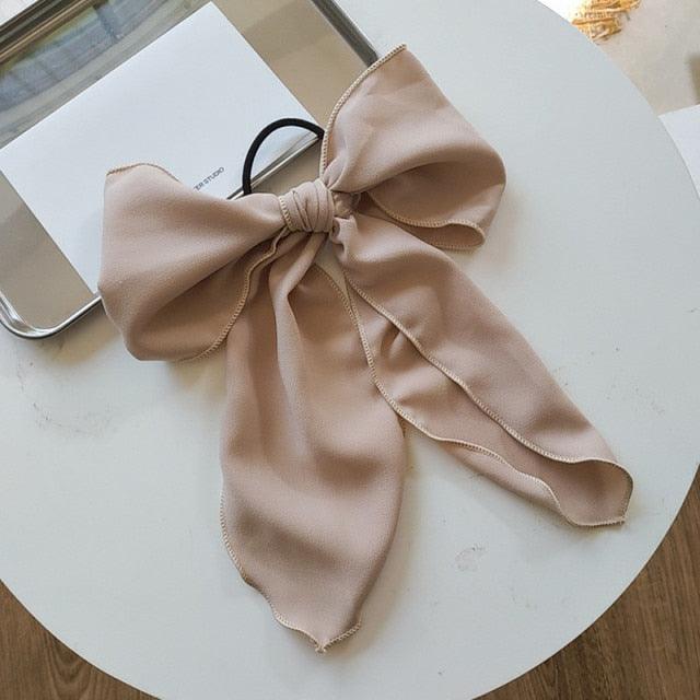 Beige bowknot hair scrunchie with cream bow and long ribbon ends.