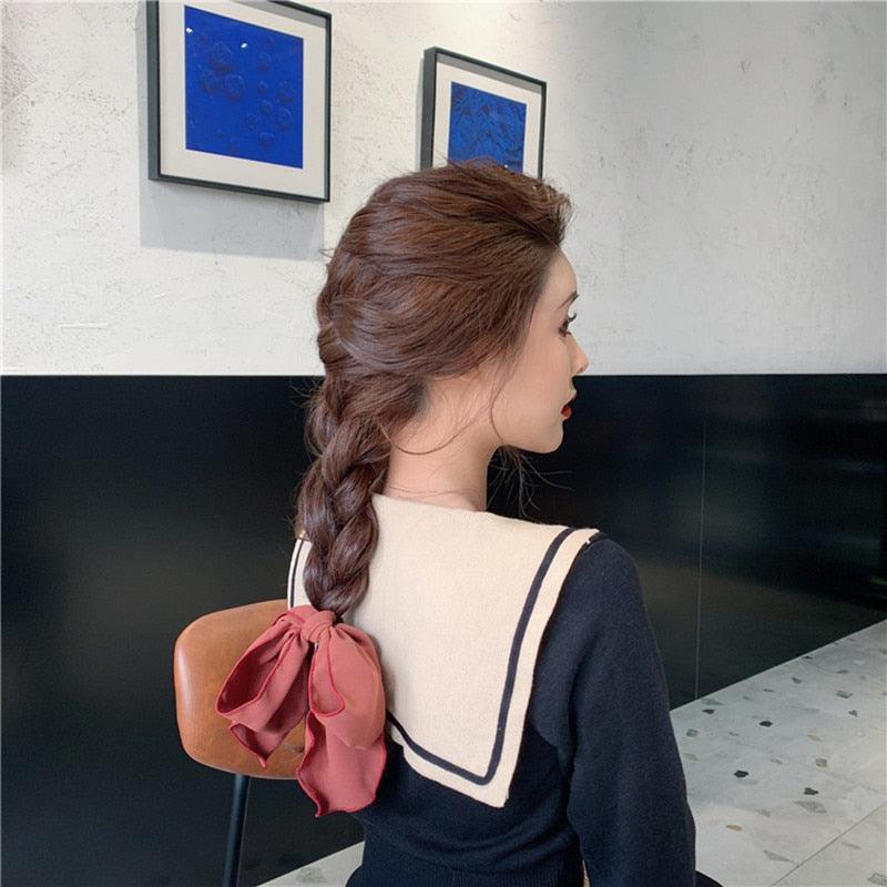 Back view of hair with red-pink bow scrunchie elastic hair band