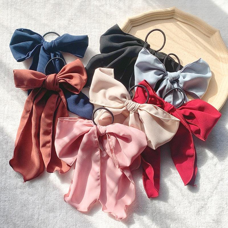 Assorted bowknot hair scrunchies set in navy, cream, red, and pink tones