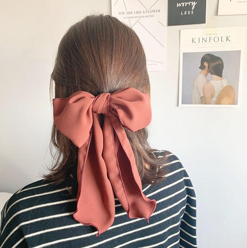 Rose-brown bowknot hair scrunchie with long tied bow on ponytail