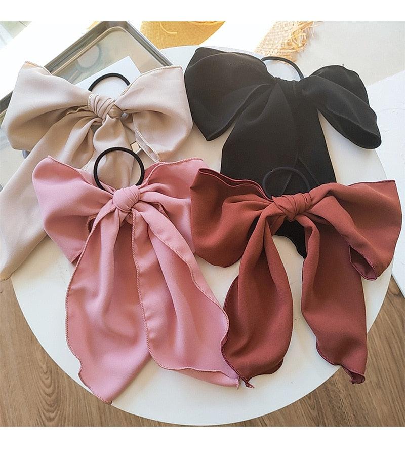 Set of satin bow hair scrunchies: beige, blush pink, rust red, and black