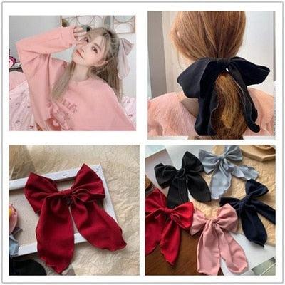 Assorted bowknot hair scrunchies collage in red, pink, navy, and cream