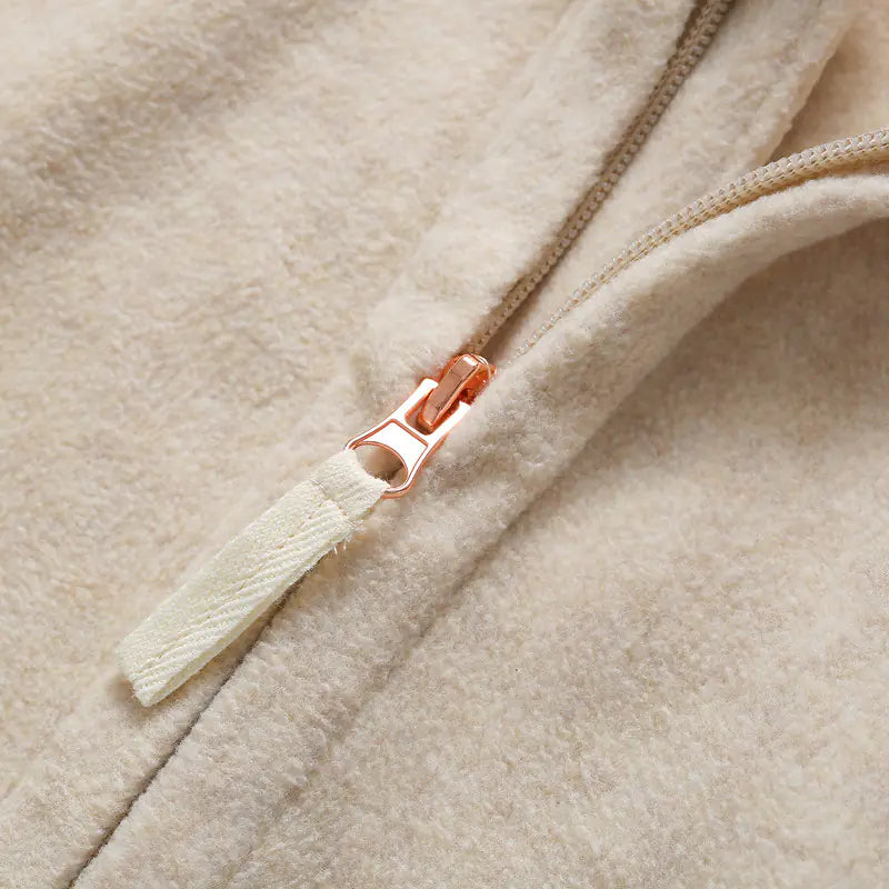 Light beige fleece jacket zipper with orange pull tab