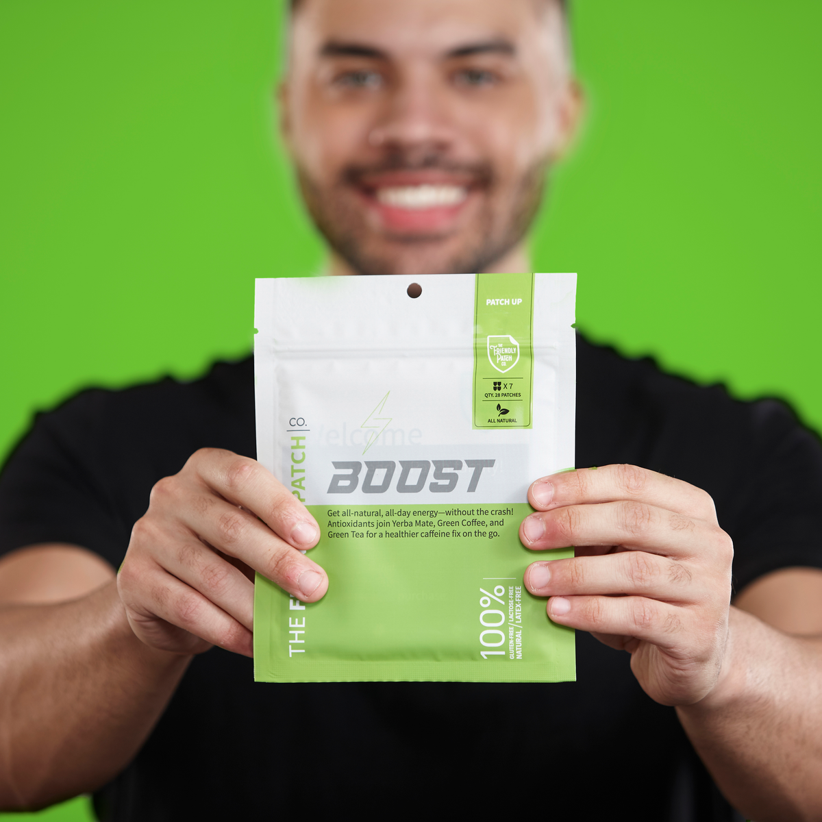 Person holding a green Boost energy patch pouch