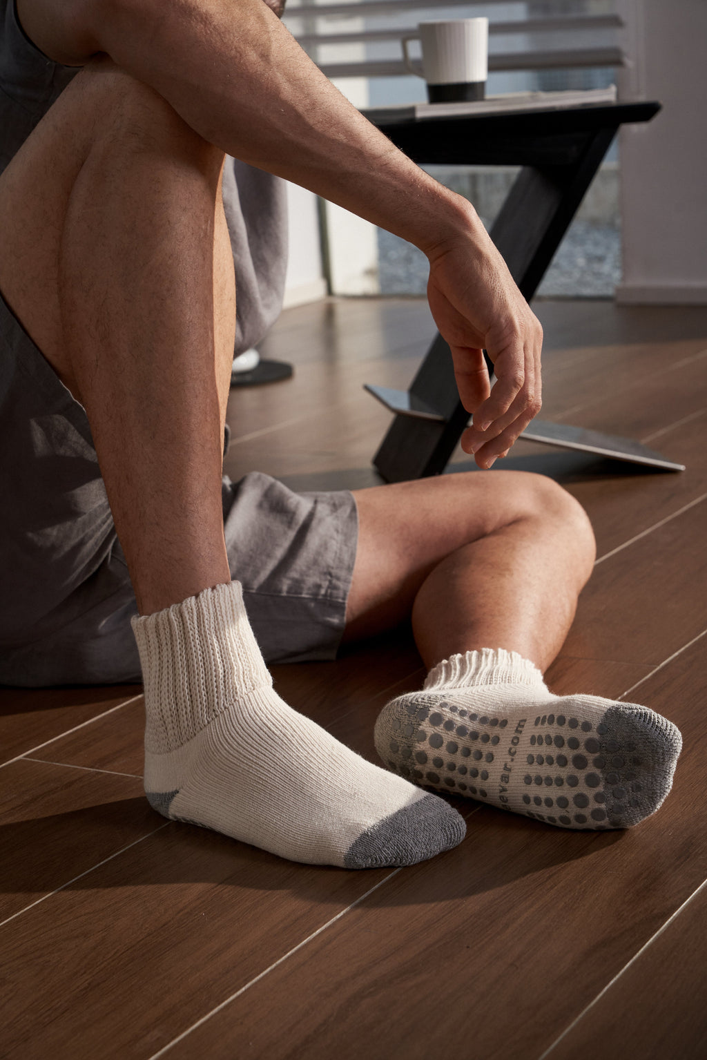 Men’s white crew socks with ribbed cuff and gray non-slip dotted sole grip