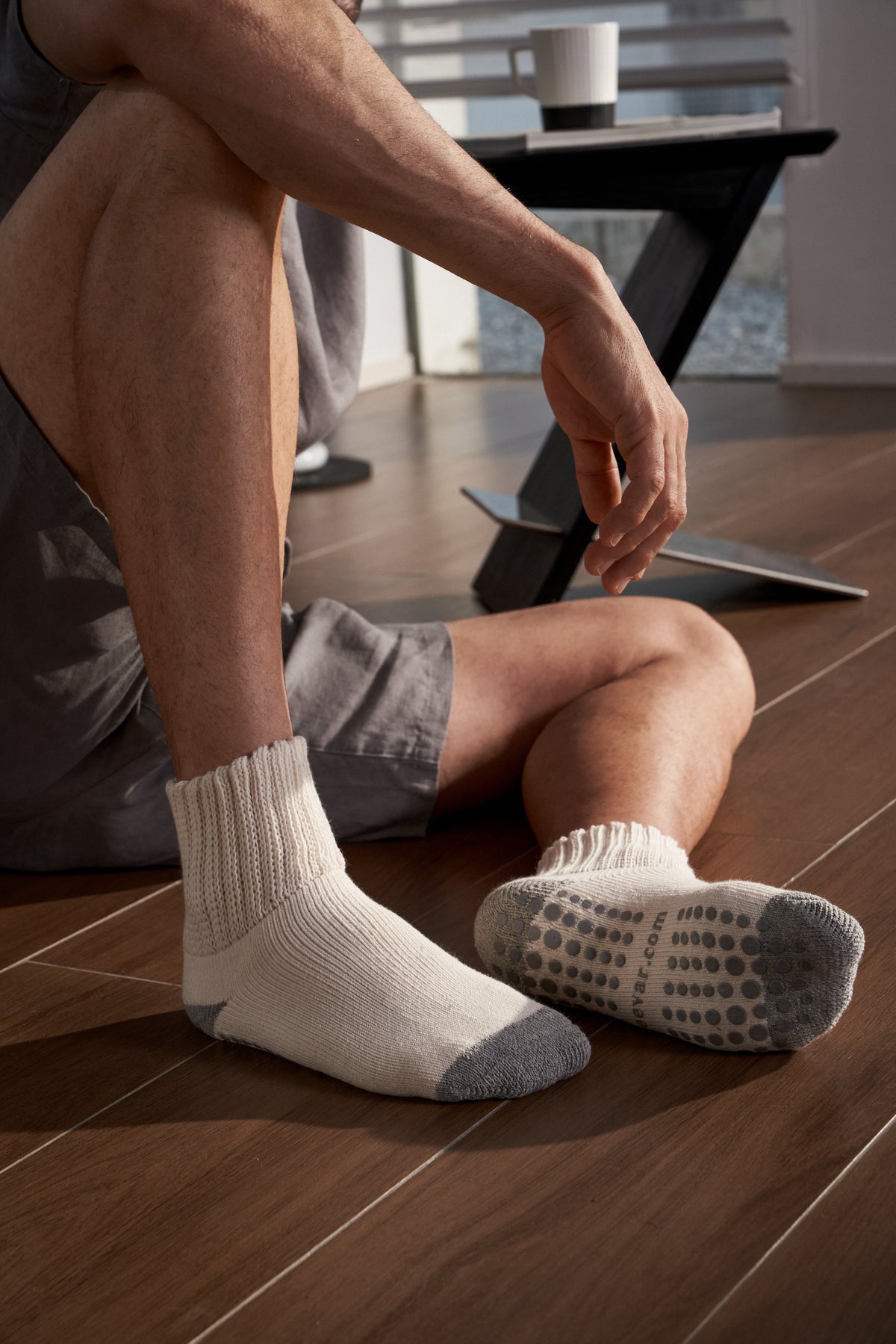 Men’s white crew socks with ribbed cuff and gray non-slip dotted sole grip