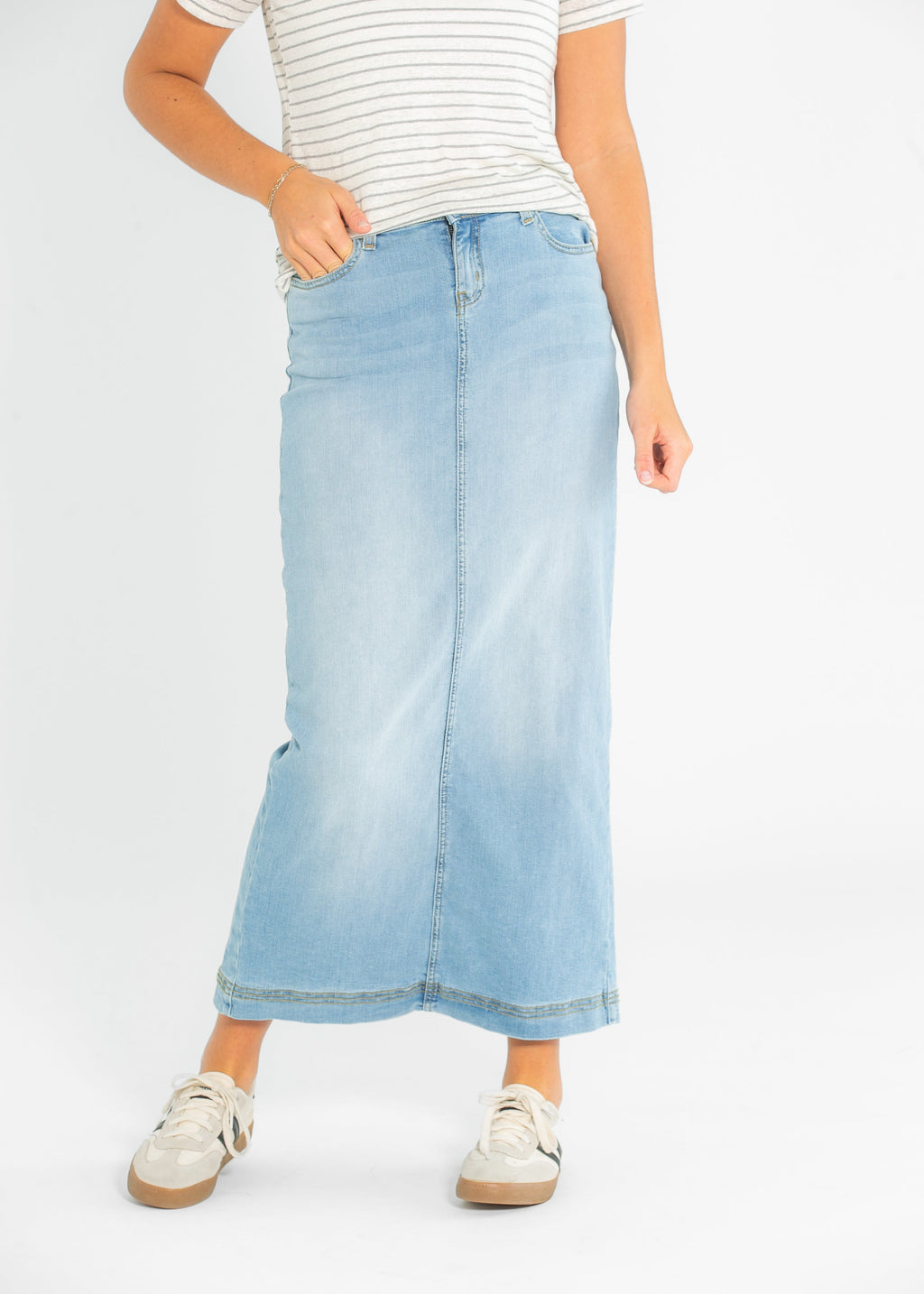 Light wash denim maxi skirt with front seam and five-pocket styling