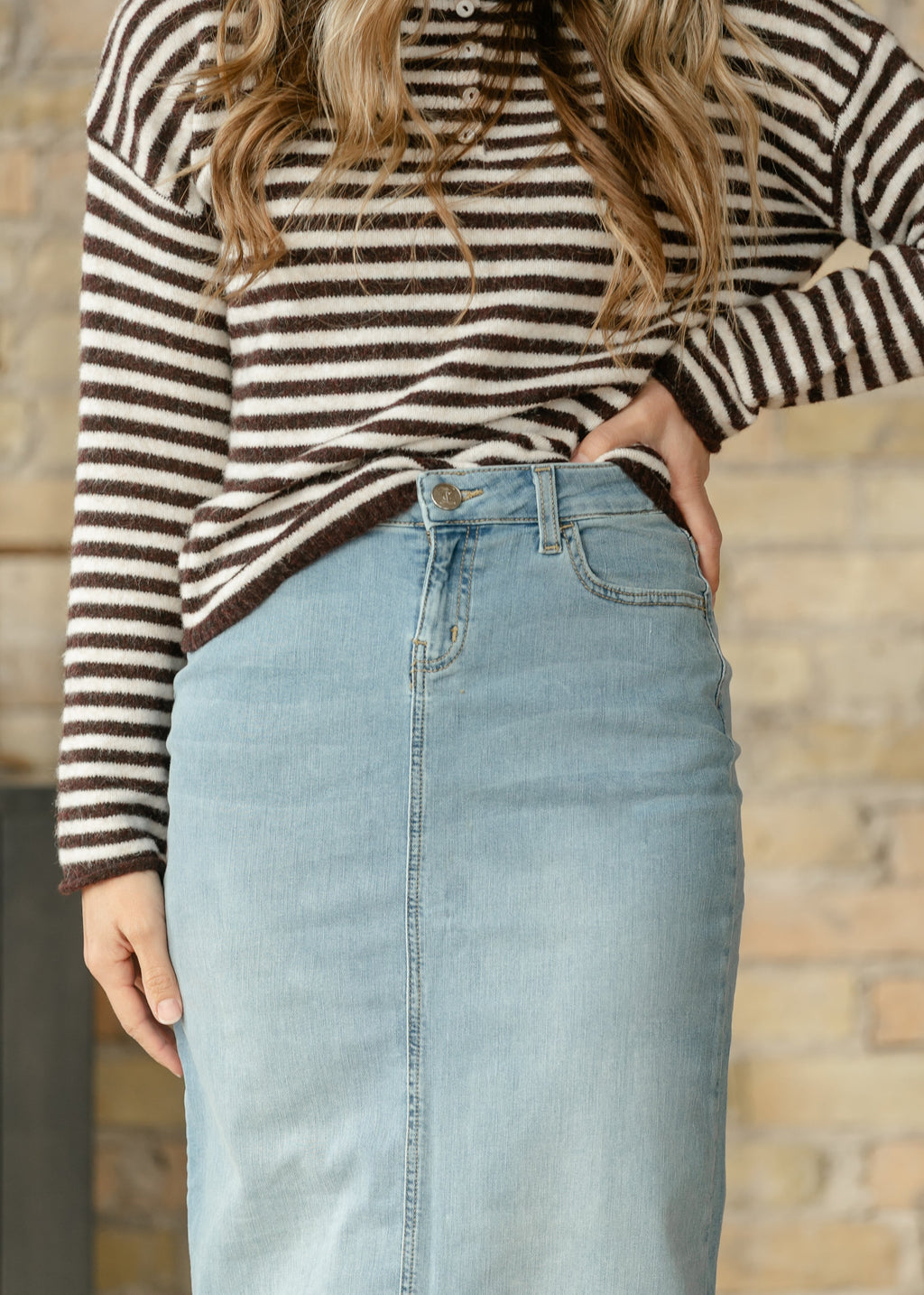 Light wash denim maxi skirt with button closure and five-pocket styling