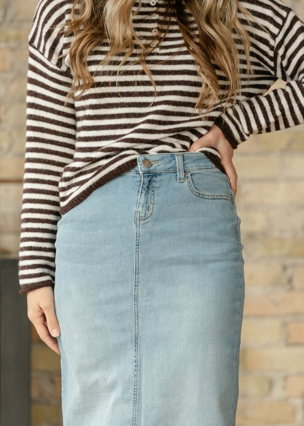 Light wash denim maxi skirt with button closure and five-pocket styling