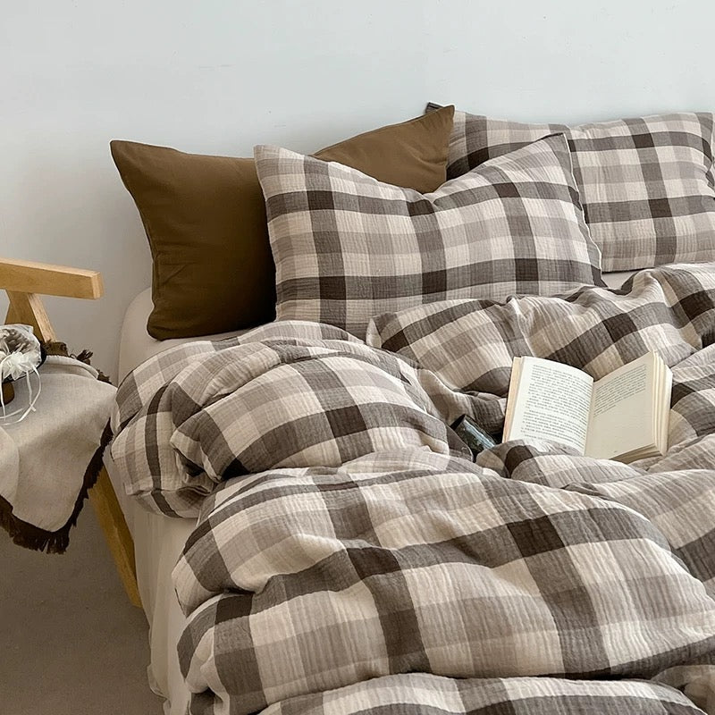 Brown-and-gray plaid duvet cover set with matching pillow shams and a solid brown pillow.
