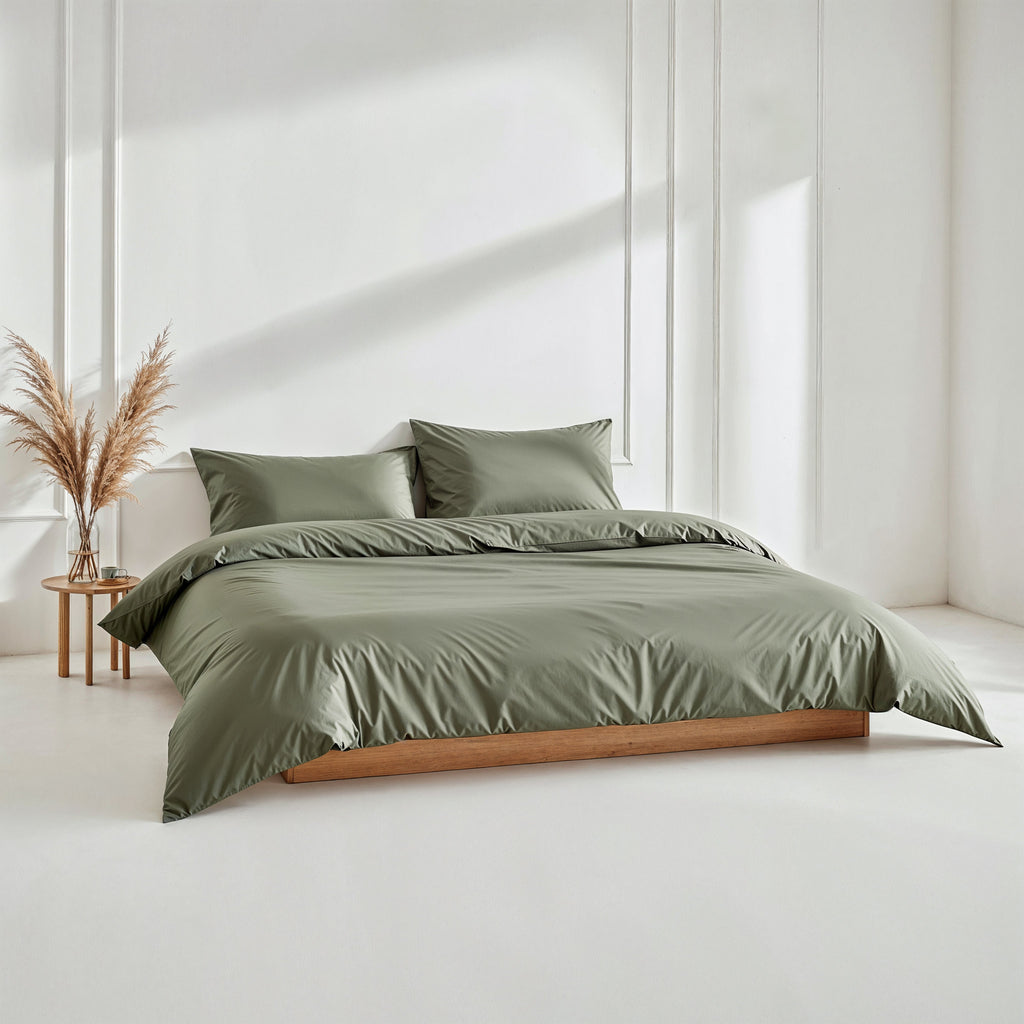 Olive green sateen bedding set with duvet and two matching pillows.