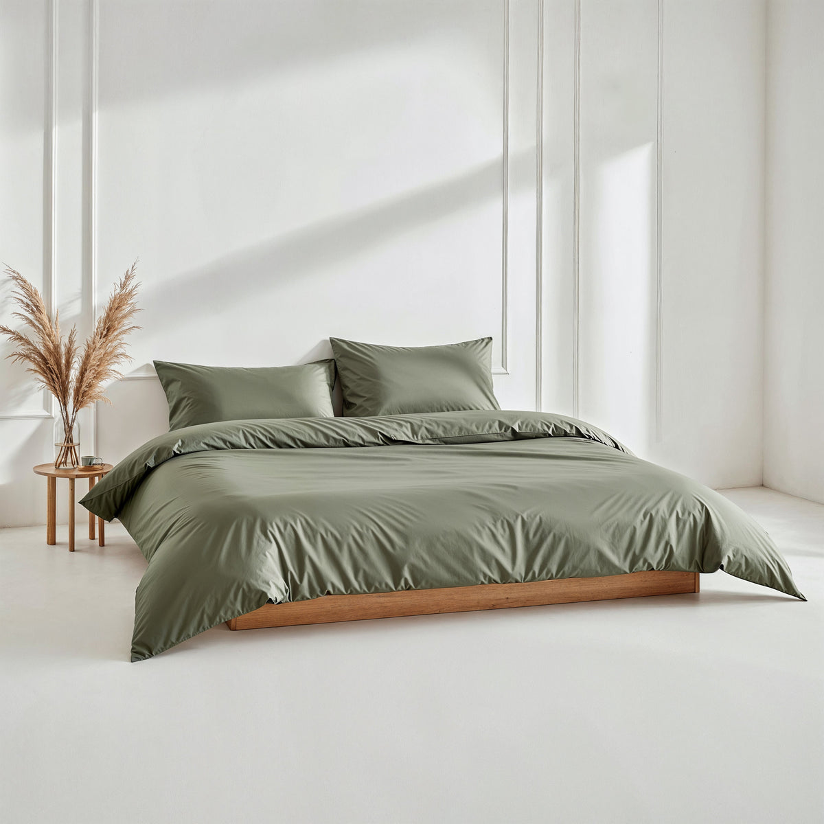 Olive green sateen bedding set with duvet and two matching pillows.