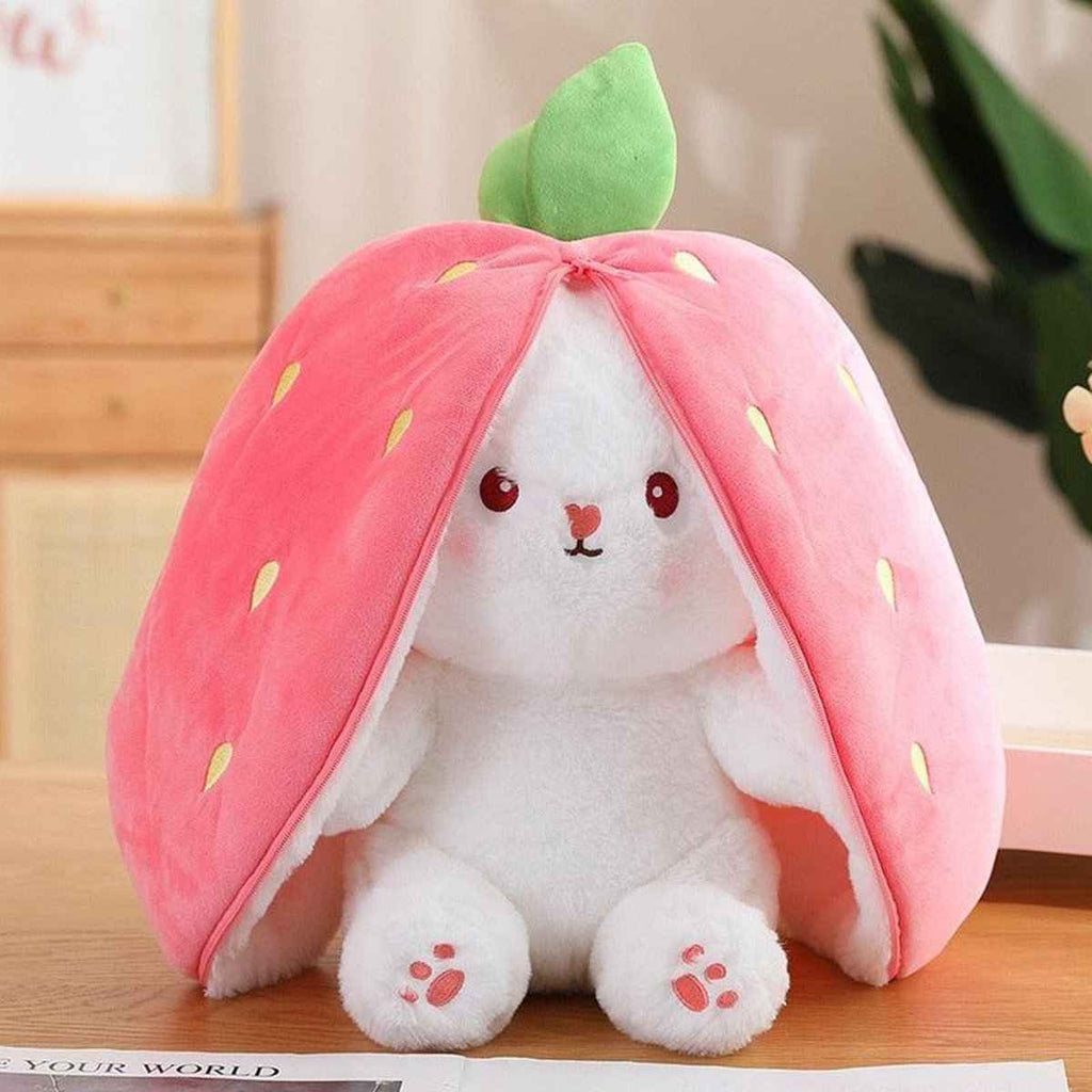 Reversible strawberry bunny plush with pink hood, green leaf, and white fluffy body