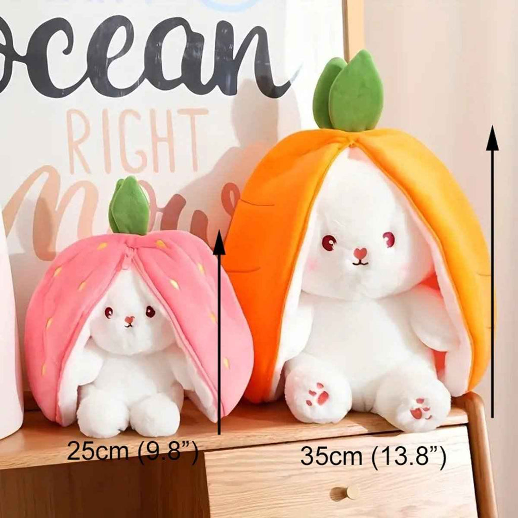 Reversible bunny plush with pink strawberry and orange carrot hoods, shown side by side