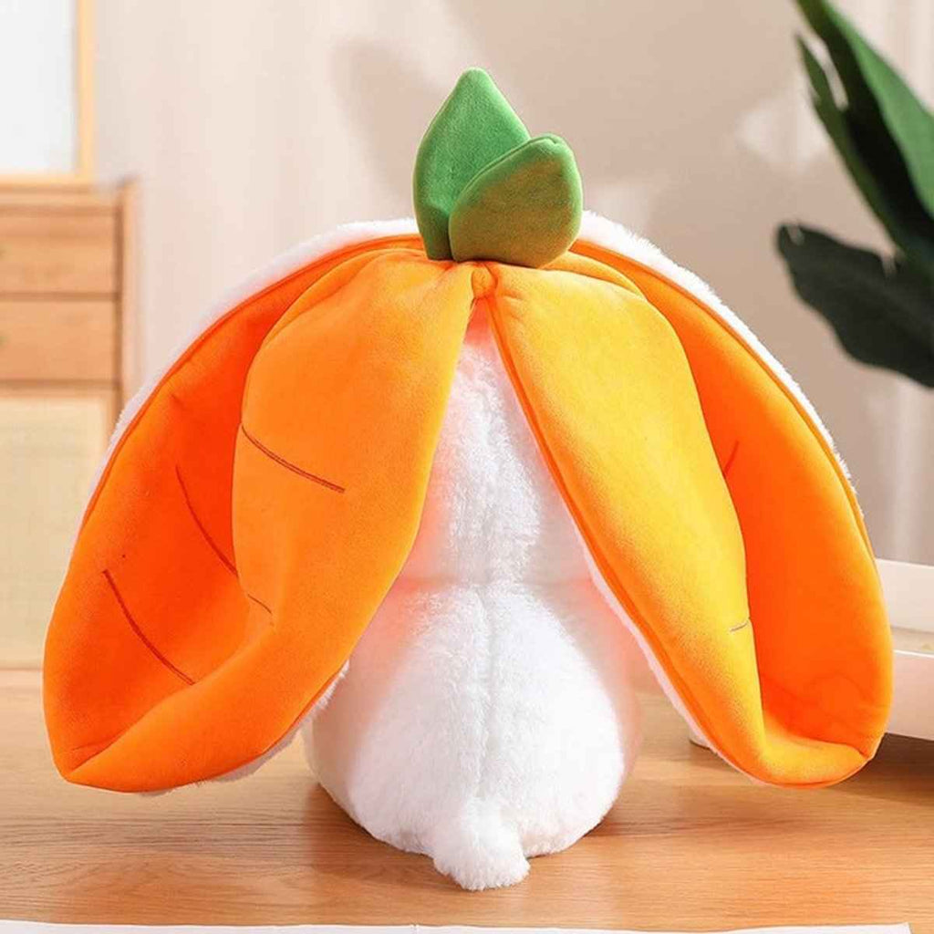 Reversible carrot bunny plush with orange hood, yellow lining, and green leaf top