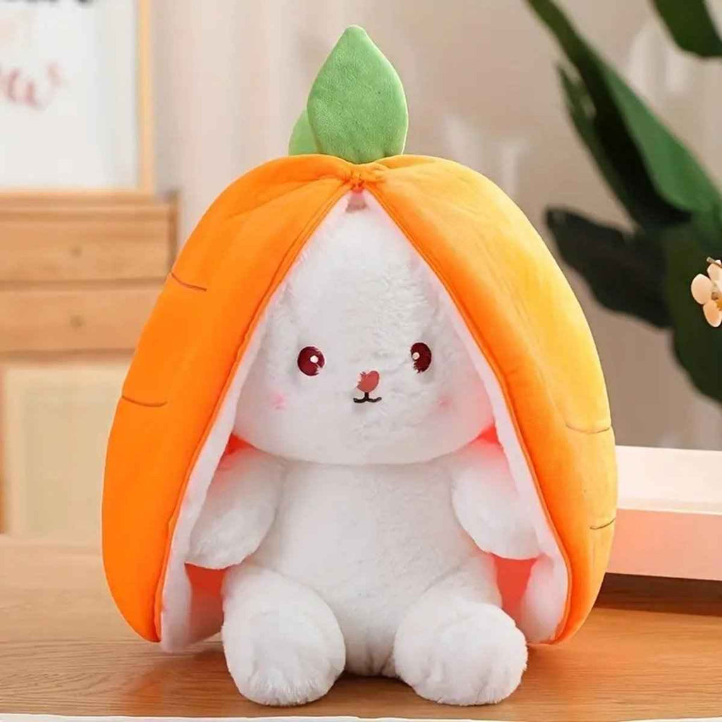 Reversible plush bunny toy in orange pod with green leaf, white bunny face and paws