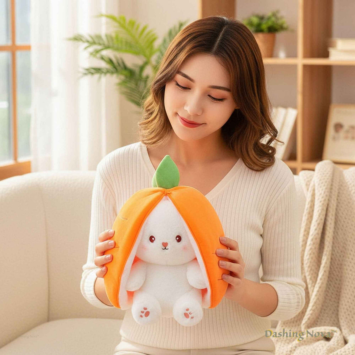 Reversible bunny plush toy showing orange side with green leaf and white face