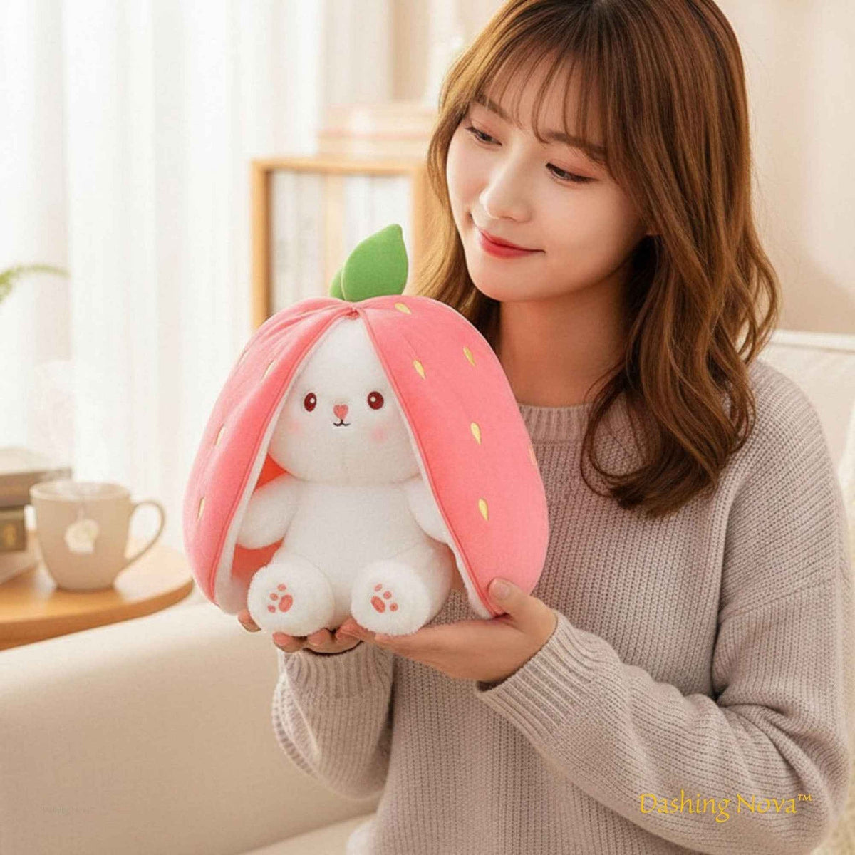 Pink strawberry bunny plush toy, front view with soft white paws and smiling face