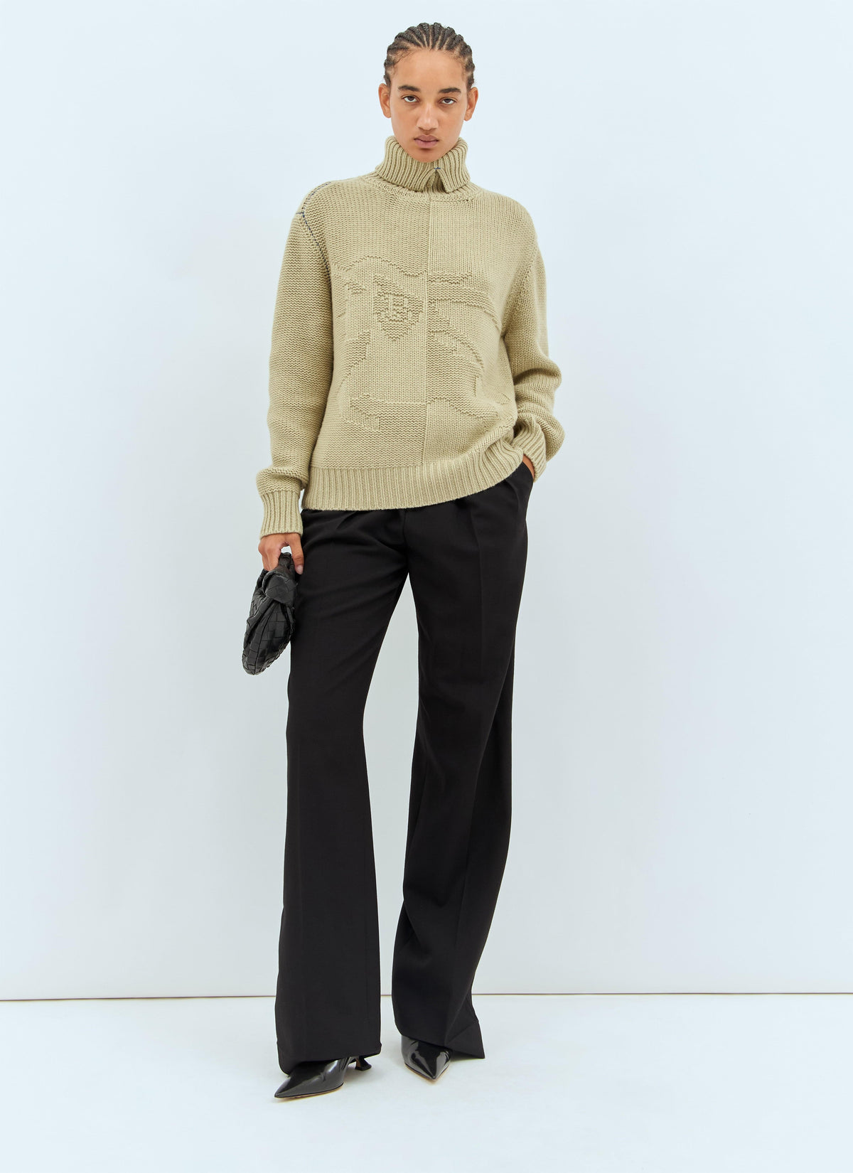 Women’s cream cashmere sweater with high turtleneck and tonal front emblem