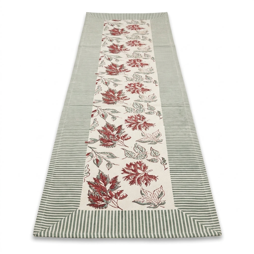 Cotton table runner with red leaf motifs on cream ground and blue striped trim