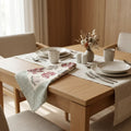 Dining table with table runner featuring red autumn leaves and slate-blue striped sides