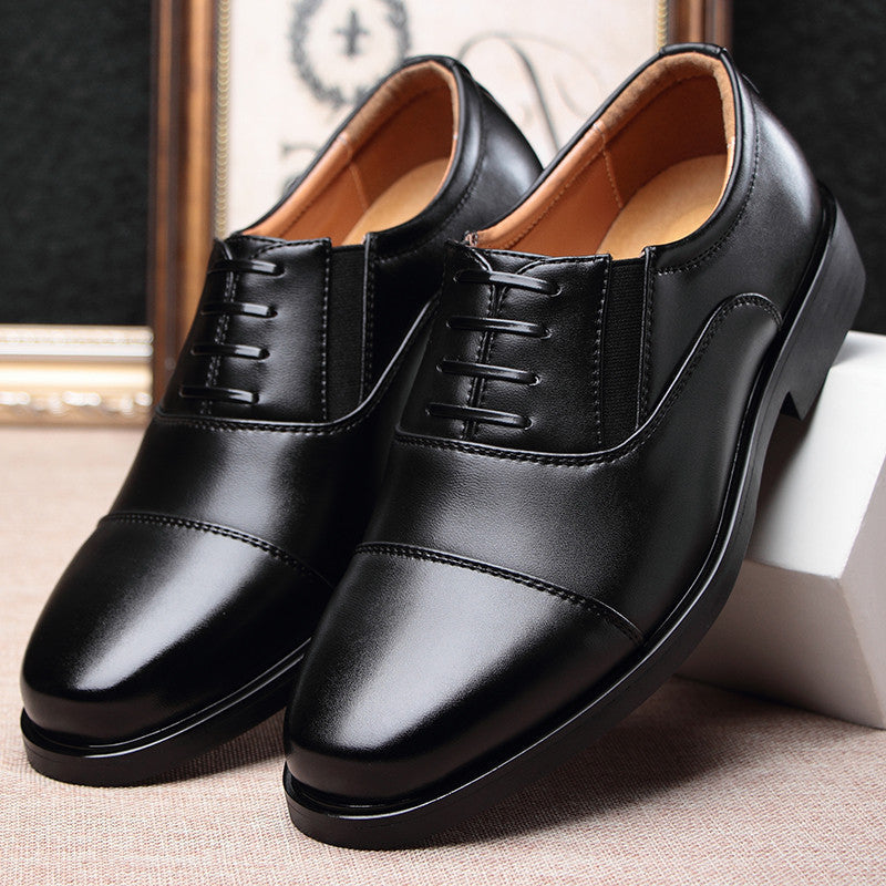 Pair of men's black leather lace-up dress shoes with decorative side panels
