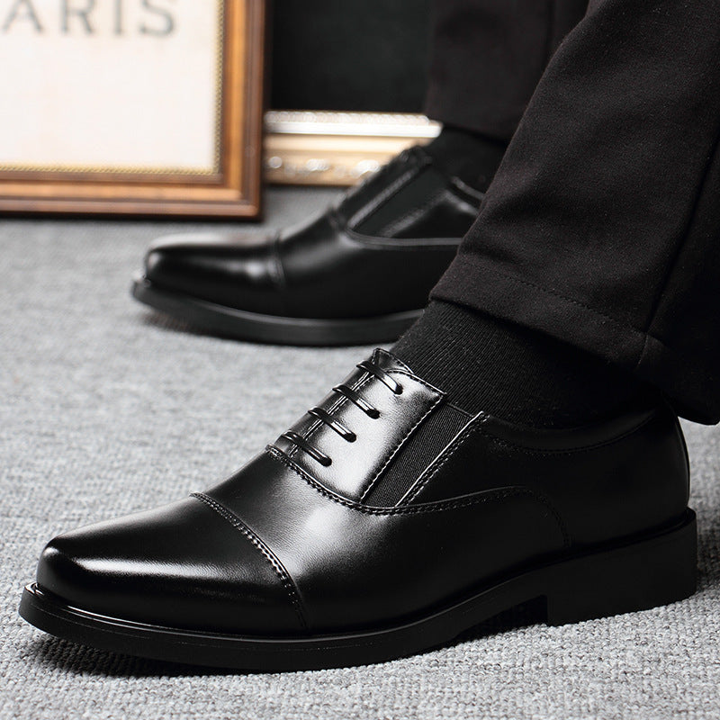 Men's black leather lace-up dress shoes on textured floor, low block heel