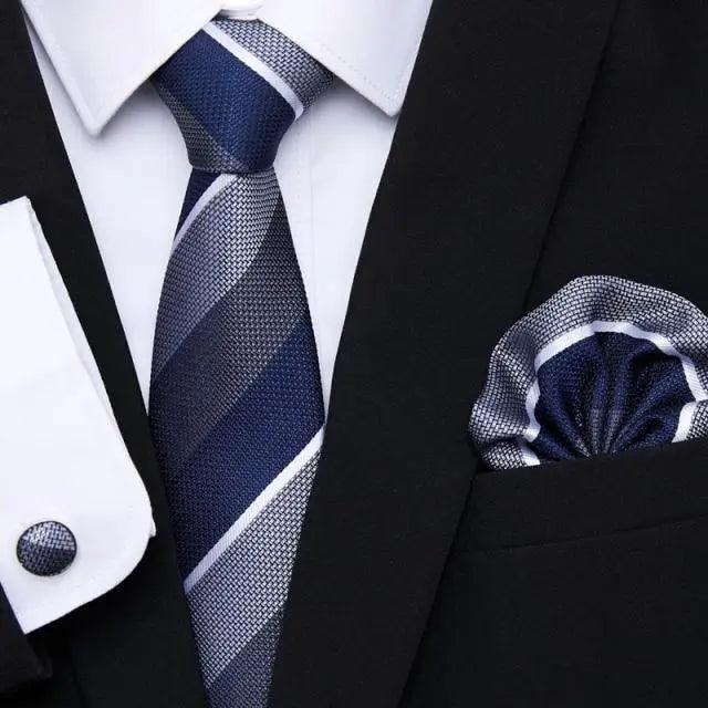 Navy and gray striped silk tie with matching pocket square and black jacket cufflinks