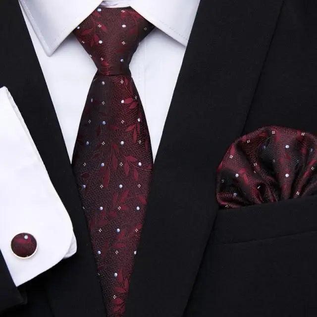 Burgundy speckled silk tie and matching pocket square with black jacket and shirt cufflinks