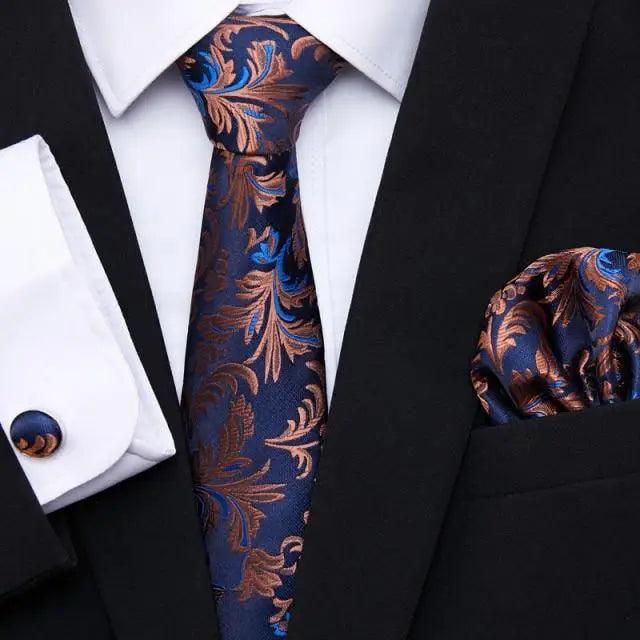 Blue and rust ornate silk tie with matching pocket square and black jacket cufflinks