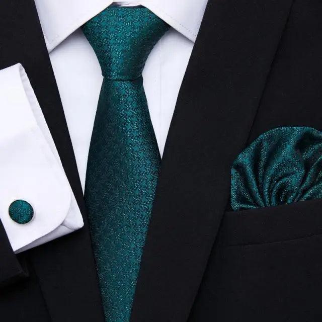 Teal textured silk tie and matching pocket square with black jacket and shirt cufflinks