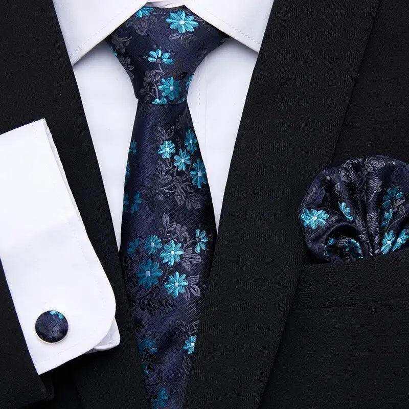 Navy floral silk tie and matching pocket square with black jacket and shirt cufflinks