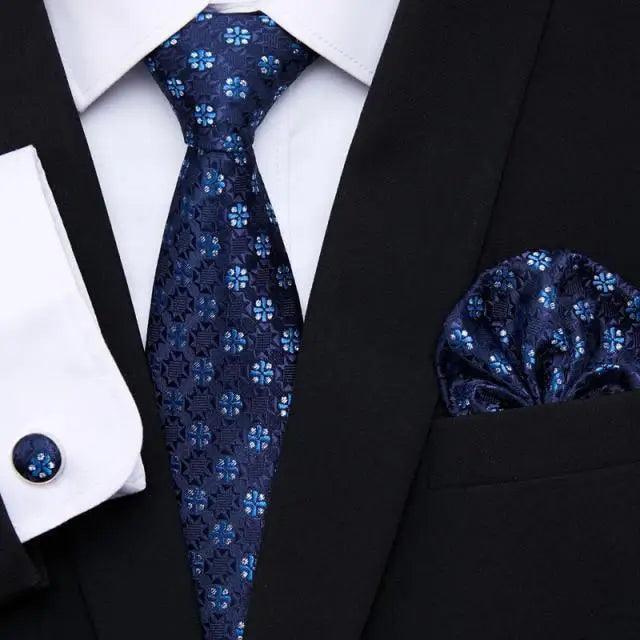 Dark blue floral silk tie and matching pocket square with black jacket and shirt cufflinks