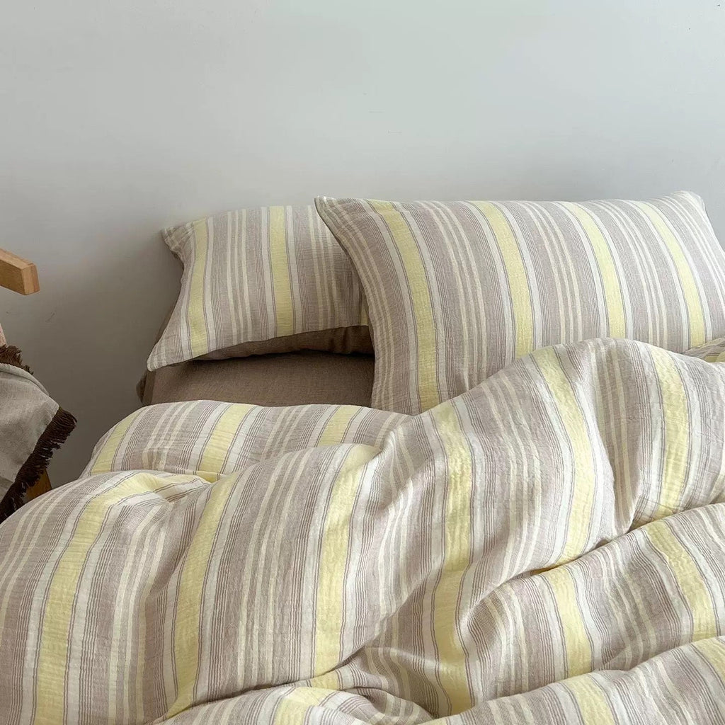 Butter yellow striped duvet cover set with coordinating pillowcases in light cream stripes.
